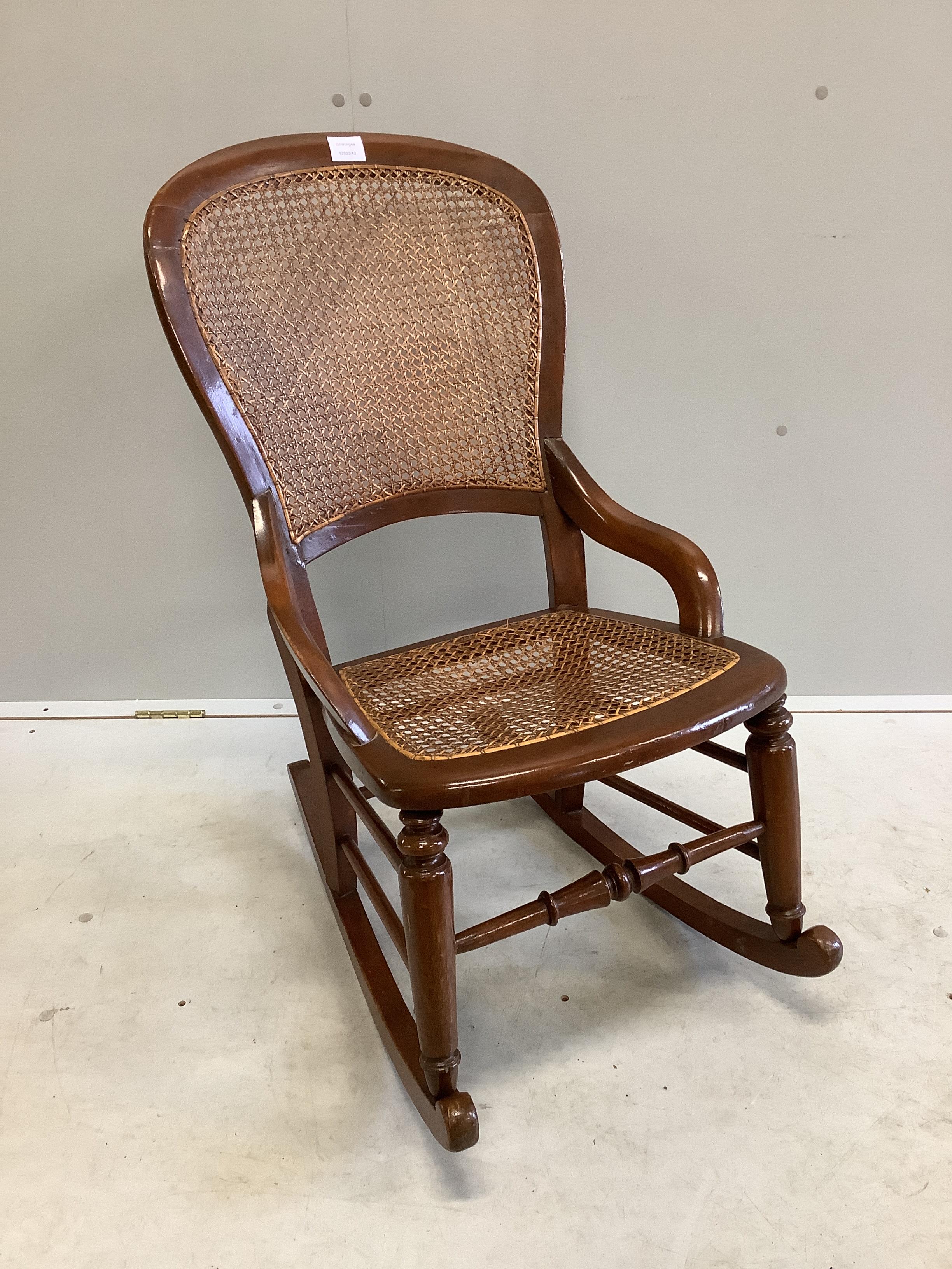 A Victorian beech cane seat and back rocking chair, width 48cm, depth 40cm, height 90cm